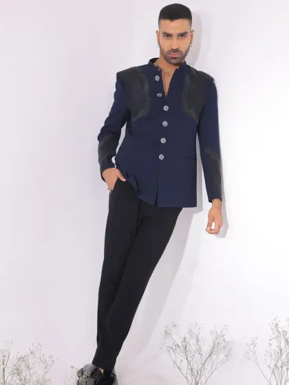 A navy blue Jodhpuri with modern, textured black panels on the shoulders and sleeves. This design is for the man who wants a subtle yet futuristic look.