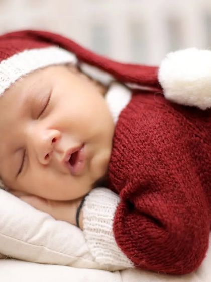 A detailed close-up capturing the peaceful expression of a baby in our Christmas photoshoot. These portraits are perfect for your family's holiday cards.