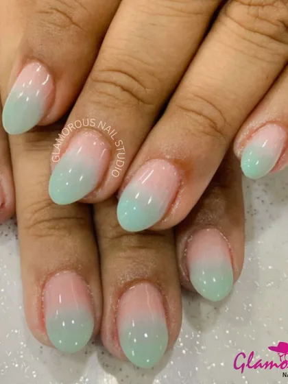 A soft and dreamy ombré effect, fading from a delicate pink at the cuticle to a minty green at the tip.