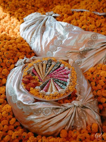 A beautiful presentation of Mehendi cones on a bed of fresh marigolds, showcasing how even the smallest details are thoughtfully styled.