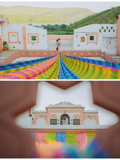 A creative shot of the couple framed by colorful Rajasthani textiles and architecture.