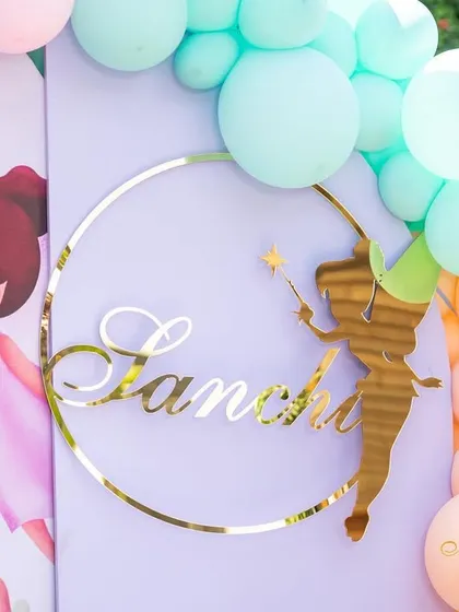 A personalized name sign for Sanchi, one of the twins, featuring a Tinkerbell-style fairy, part of the pastel fairy theme.