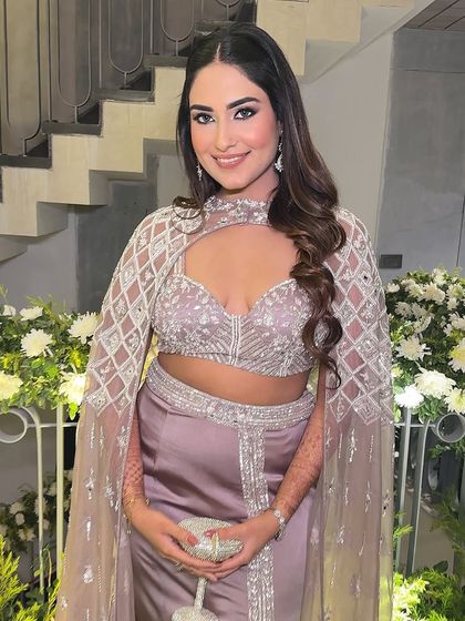 Posed and ready for the party. Her confidence and style are undeniable, and the makeup completes the glamorous look.