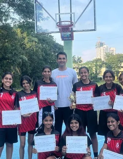 The winning girls team proudly displaying their certificates. Each certificate represents a player's contribution to the team's overall success.