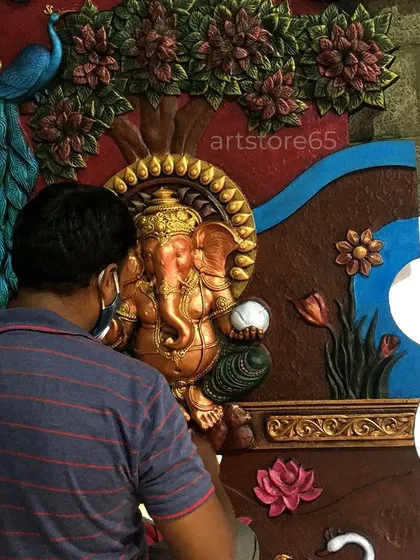 Here you can see one of our artists giving the final touches to a Ganesha mural. Every piece we make is a result of careful, hands-on work, ensuring that the final sculpture is not just an object, but a piece of art with a personal touch.