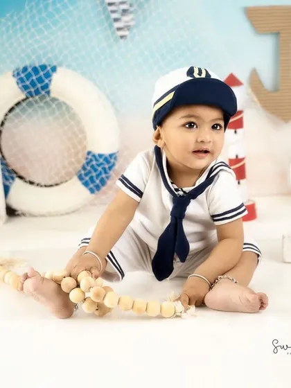 This little sailor is ready to set sail. The complete outfit and detailed nautical set make for a picture-perfect themed shoot.