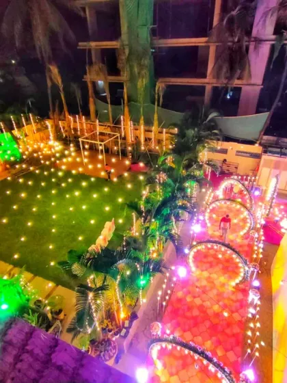 This aerial view shows how I can transform an entire outdoor space for a nighttime event. My work here included the illuminated arched walkway, lawn lighting, and the overall seating area layout to create a cohesive and magical environment.