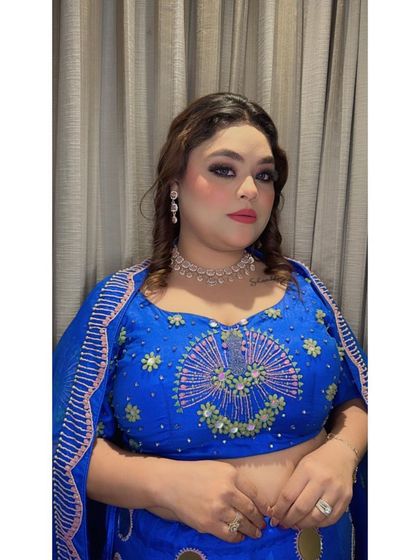 A close-up of the royal blue lehenga's blouse, showing the intricate embroidery and modern design. It's a perfect blend of traditional craft and contemporary style.