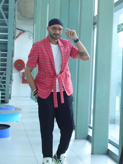 Another shot of Harbhajan Singh in the pink striped blazer, showing how it can be styled for a confident and modern look.