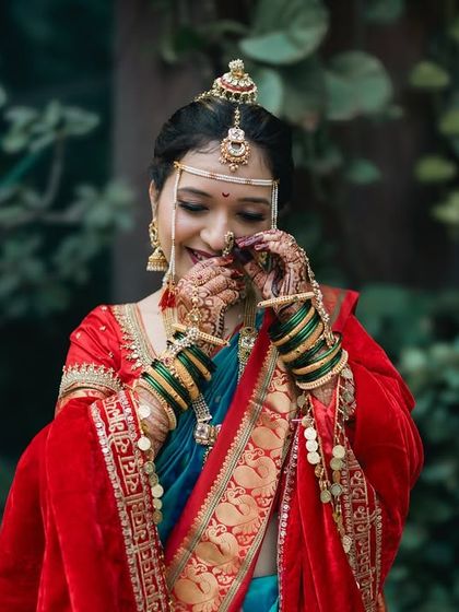 A shy, happy Maharashtrian bride captured in a candid moment.