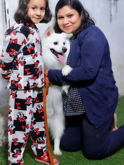 A mother and daughter sharing a special moment with their happy pup. We love seeing families come together to celebrate their furry members.