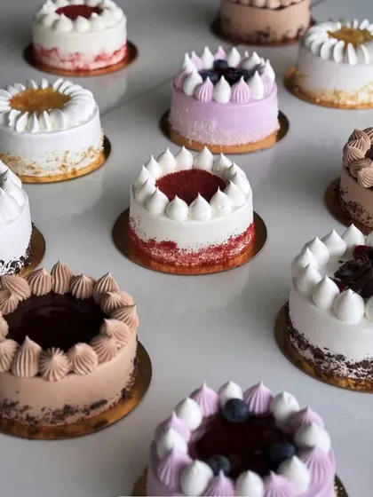 An array of our beautifully decorated mini cakes, each with its own unique flavour and design. A cake is always a good idea to start the day or celebrate a small win.