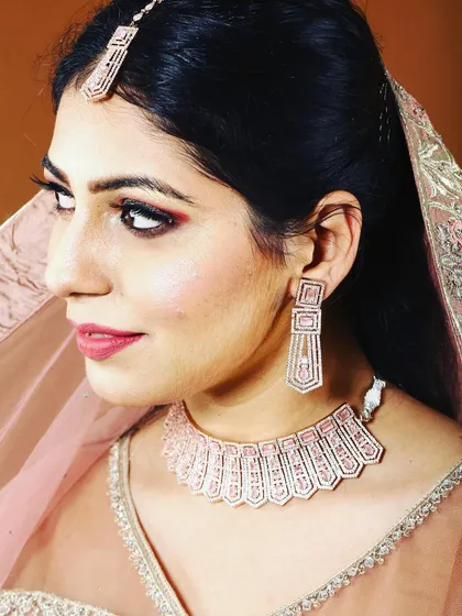 Celebrate Diwali with a complete, elegant look. This rose-gold plated necklace set with matching earrings and tikka is perfect for adding that festive sparkle.