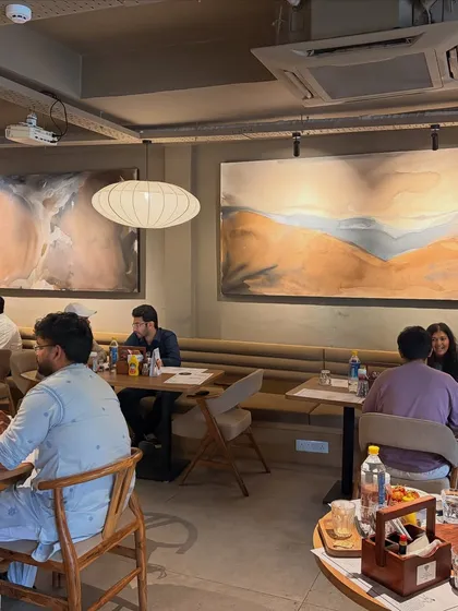 My art isn't just for homes. I love creating custom pieces for commercial spaces like this one for Sidewalk cafe in Lucknow. These large 8-foot canvases set the mood and create a memorable atmosphere for customers, making the space feel unique and curated.