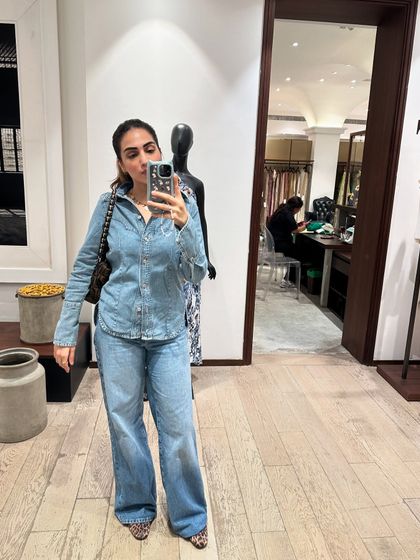 A mirror selfie in a full denim-on-denim look, this time with a light wash shirt and matching jeans.