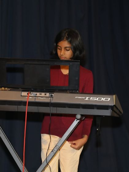 Another student keyboardist contributing to the 'Vande Mataram' ensemble.