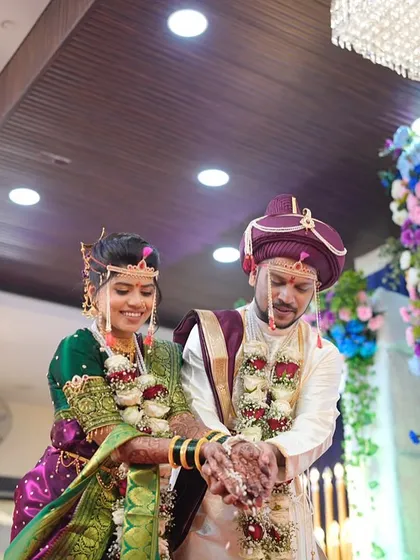 A candid moment from the wedding ceremony, with the couple sharing a happy laugh.