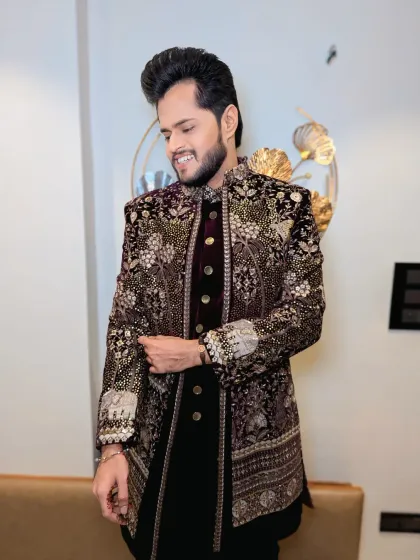 Adjusting the sleeve of his magnificent sherwani. Every detail of the look, from the outfit to the grooming, is carefully considered.