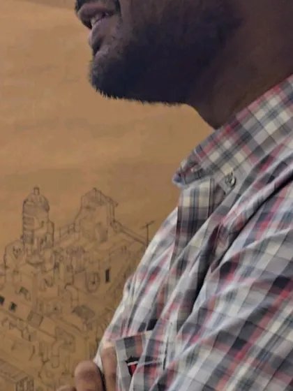 Ajith standing with his work. Though he remained dissatisfied, thinking it sketchy and incomplete, his work was a surprise to many and a testament to his unpredictable talent.