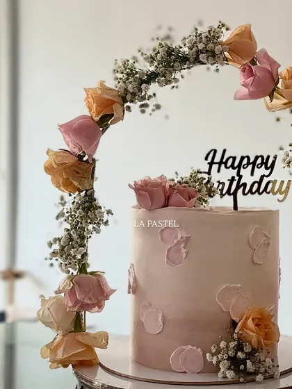 For a dreamy and elegant birthday, I created this beautiful cake with a tiara-like arch of fresh roses and baby's breath. The soft pastel pink ombre and delicate textures make it a truly special celebration cake.