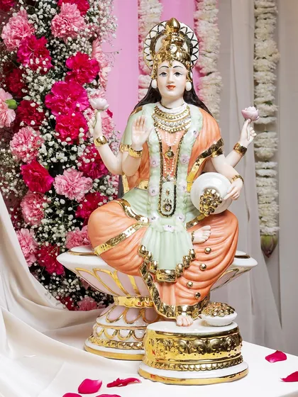A magnificent, large porcelain statue of Goddess Lakshmi, painted in serene pastel hues with rich gold detailing. Seated on a lotus, she embodies grace, beauty, and the promise of abundance.