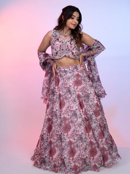 A full-length shot of a beautiful floral print lehenga. The combination of pinks and purples on a light base makes it a fresh and youthful choice.