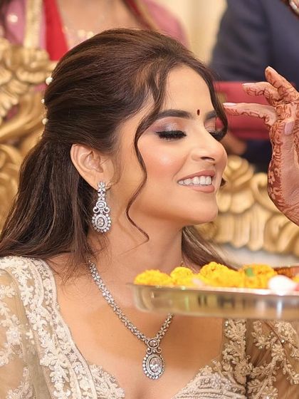 A candid moment from the ceremony. Her makeup is designed to look flawless from every angle, even in close-up shots.