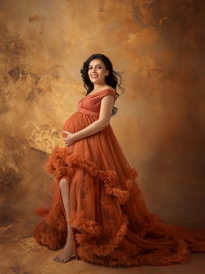 A full-length view of this incredible ruffled gown against a painterly, textured backdrop.