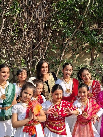 A happy group photo with my students after their Christmas Fest performance. Their colorful costumes and bright smiles say it all.