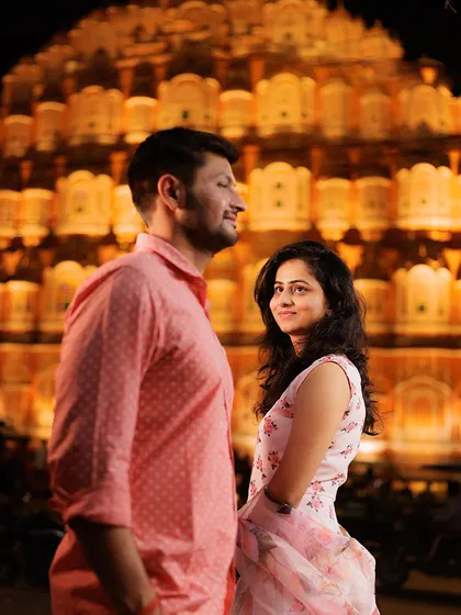 We captured this moment against the iconic Hawa Mahal in Jaipur, its golden facade glowing at night. This shot embodies the royal romance and timeless elegance that a destination pre-wedding shoot in the Pink City offers.