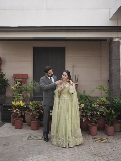 A candid moment between the couple. Her makeup looks flawless and natural, letting her happiness be the focus.