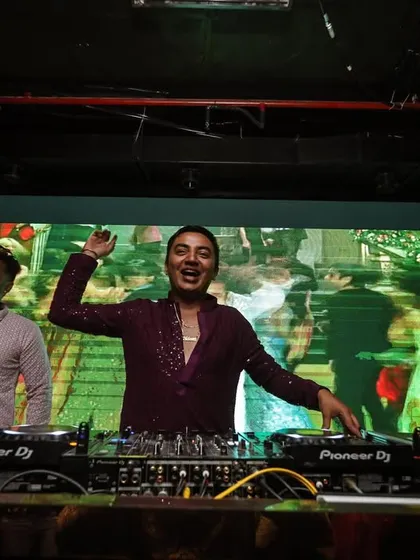 Enjoying the vibe with my team behind the decks. We work together to ensure the energy never drops.