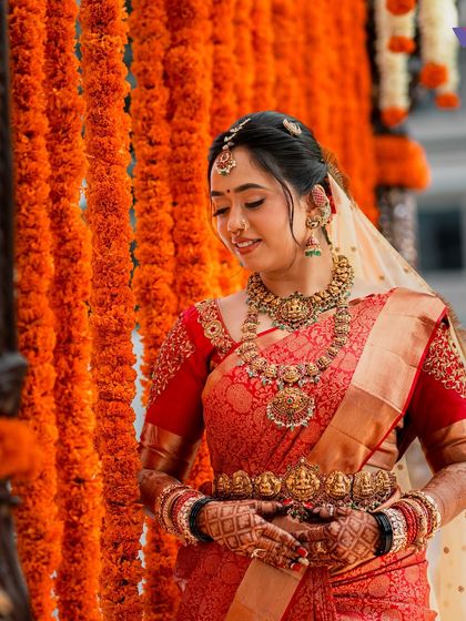 A beautiful shot of the bride looking down, highlighting her jewellery and the details of her makeup.