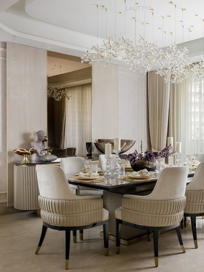 A view of one of our elegantly styled dining rooms. We focus on combining statement lighting, comfortable seating, and high-quality materials like marble and brass to create spaces that are perfect for both everyday meals and special occasions.