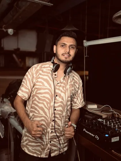 In my element, behind the decks. This is where I feel most at home, lining up the next track to keep the party moving. Ready for the beat to drop.