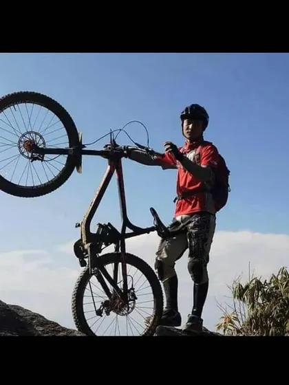 It's not all serious racing. Enjoying the moment after a tough climb in Bhutan. Bike handling skills like this wheelie are not just for show; they build balance and control that translate directly to better trail riding.