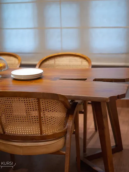 My live-edge teak wood table paired with 'Modis' rattan chairs. Each table is a unique work of nature, bringing warmth and character to your home.