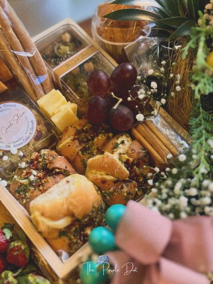 A peek at the savory side of the hamper, featuring fresh-baked garlic bread, olives, cheese, and breadsticks.