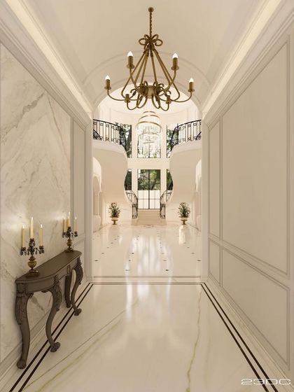 A long, vaulted corridor with polished marble floors leads towards the grand lobby. A classic console table and candelabra add a touch of timeless elegance, setting the tone for the luxurious experience that awaits.