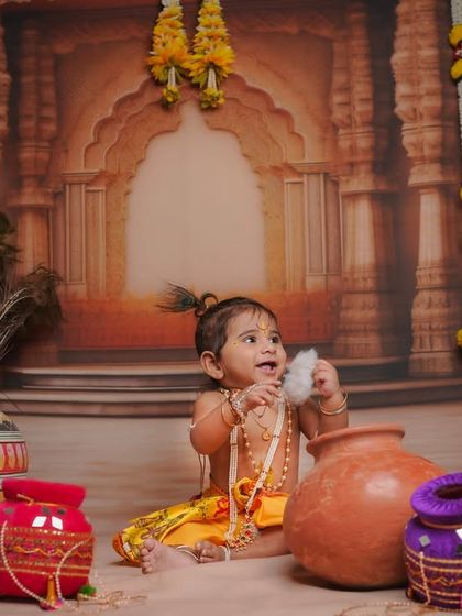 A candid moment of our little Krishna enjoying a bit of 'makhan' (butter). We use a variety of props and setups to tell a complete story during our themed baby photoshoots.