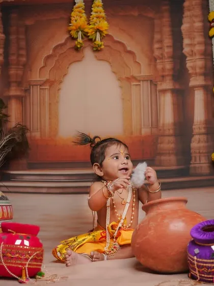 A candid moment of our little Krishna enjoying a bit of 'makhan' (butter). We use a variety of props and setups to tell a complete story during our themed baby photoshoots.