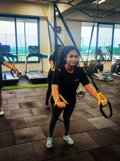 Our training extends to the gym. Here, our athletes work on their physical fitness using TRX suspension trainers to build the core strength essential for shooting.