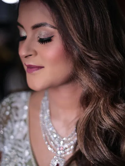 Another angle of the Sangeet look, showing the flawless blend of eyeshadow and the soft curls of her hair.