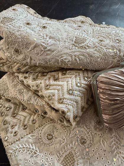 A folded view of the saree, emphasizing the richness of the embellishments and the luxurious feel of the fabric.