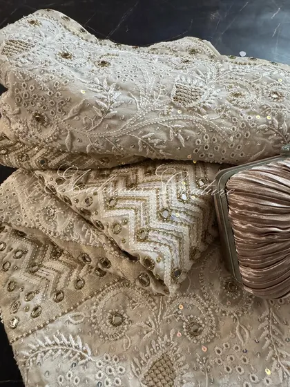 A folded view of the saree, emphasizing the richness of the embellishments and the luxurious feel of the fabric.