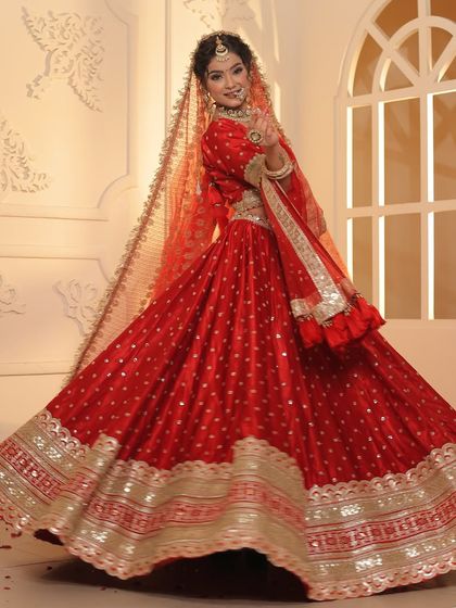 The flare on this red and gold lehenga is simply unmatched. It's a perfect choice for videographers looking to capture those breathtaking bridal twirl shots.