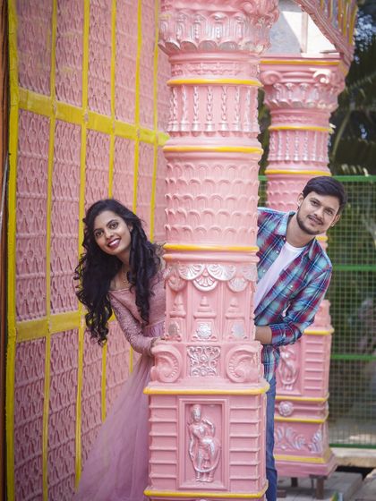 A playful game of peek-a-boo around these vibrant pink pillars. Studio shoots can be full of fun and spontaneous moments.