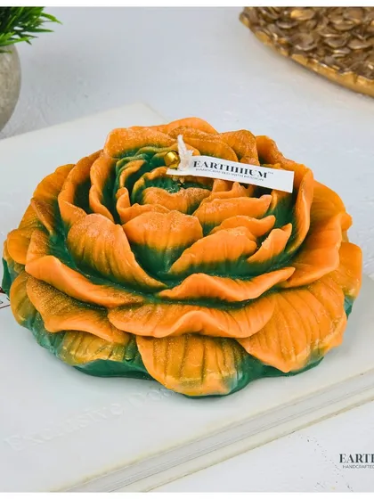 A two-toned peony pillar candle, blending orange and green for a unique, artistic look.