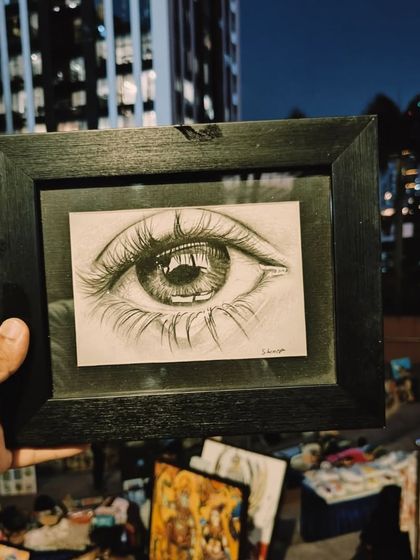 Showcasing the incredible realism of artist Lavanya's charcoal drawings at Sublime Fiesta. This close-up of an eye demonstrates her breathtaking skill.
