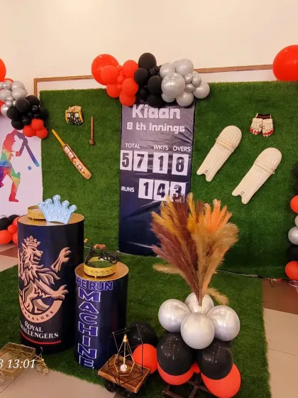 Another angle of the cricket party, showing the arrangement of the props and the balloon columns on each side.